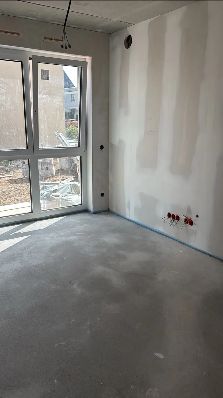 Gespachtelte Wandflächen in einem Rohbauzimmer, vorbereitet für die Beschichtung