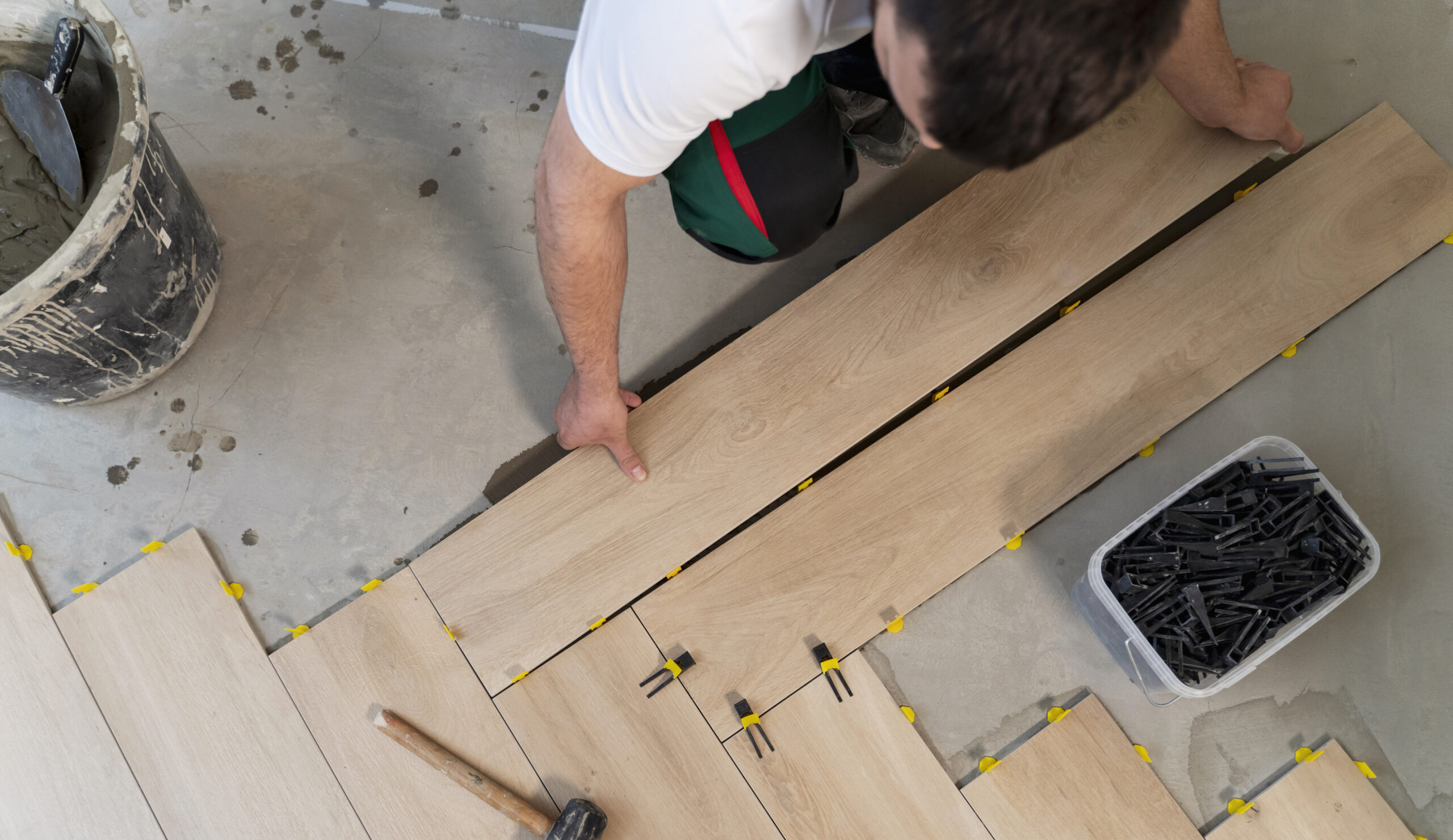 top-view-man-tiling-floor